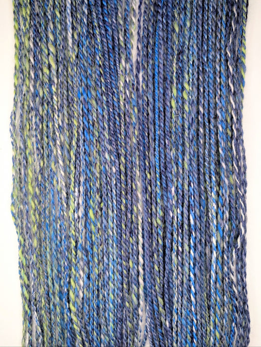 Blue and green skein of yarn on a white background